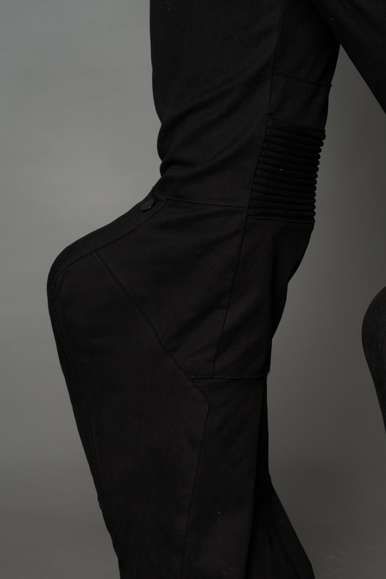 Black cotton stretch mutant pants with low waist, ribbed knee panels, and exaggerated flared legs by Namilia