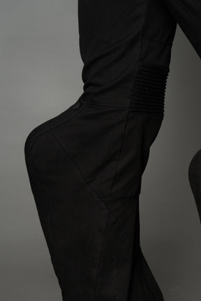 Black cotton stretch mutant pants with low waist, ribbed knee panels, and exaggerated flared legs by Namilia