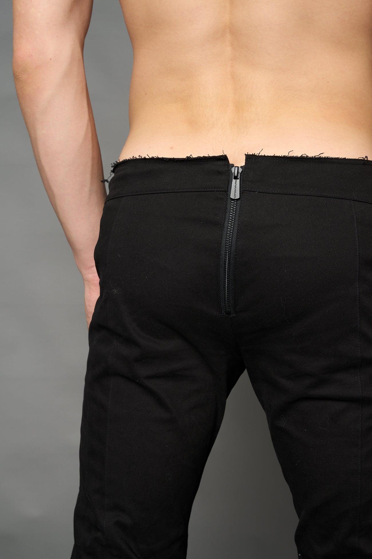 Black cotton stretch mutant pants with low waist, ribbed knee panels, and exaggerated flared legs by Namilia