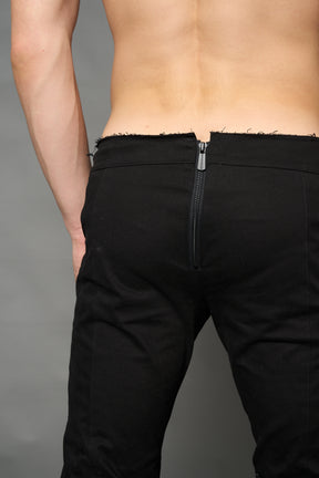 Black cotton stretch mutant pants with low waist, ribbed knee panels, and exaggerated flared legs by Namilia