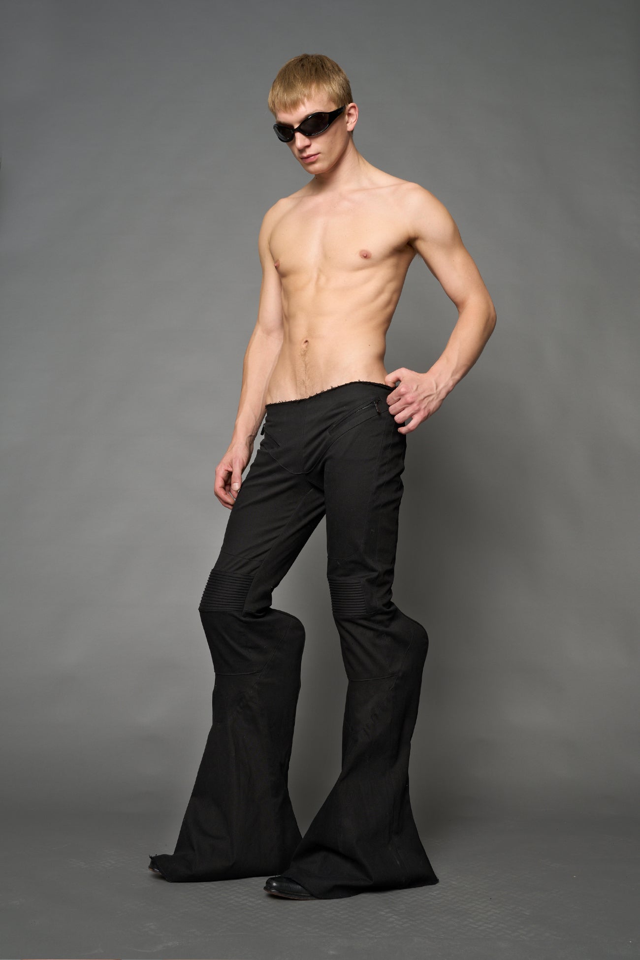 Black cotton stretch mutant pants with low waist, ribbed knee panels, and exaggerated flared legs by Namilia