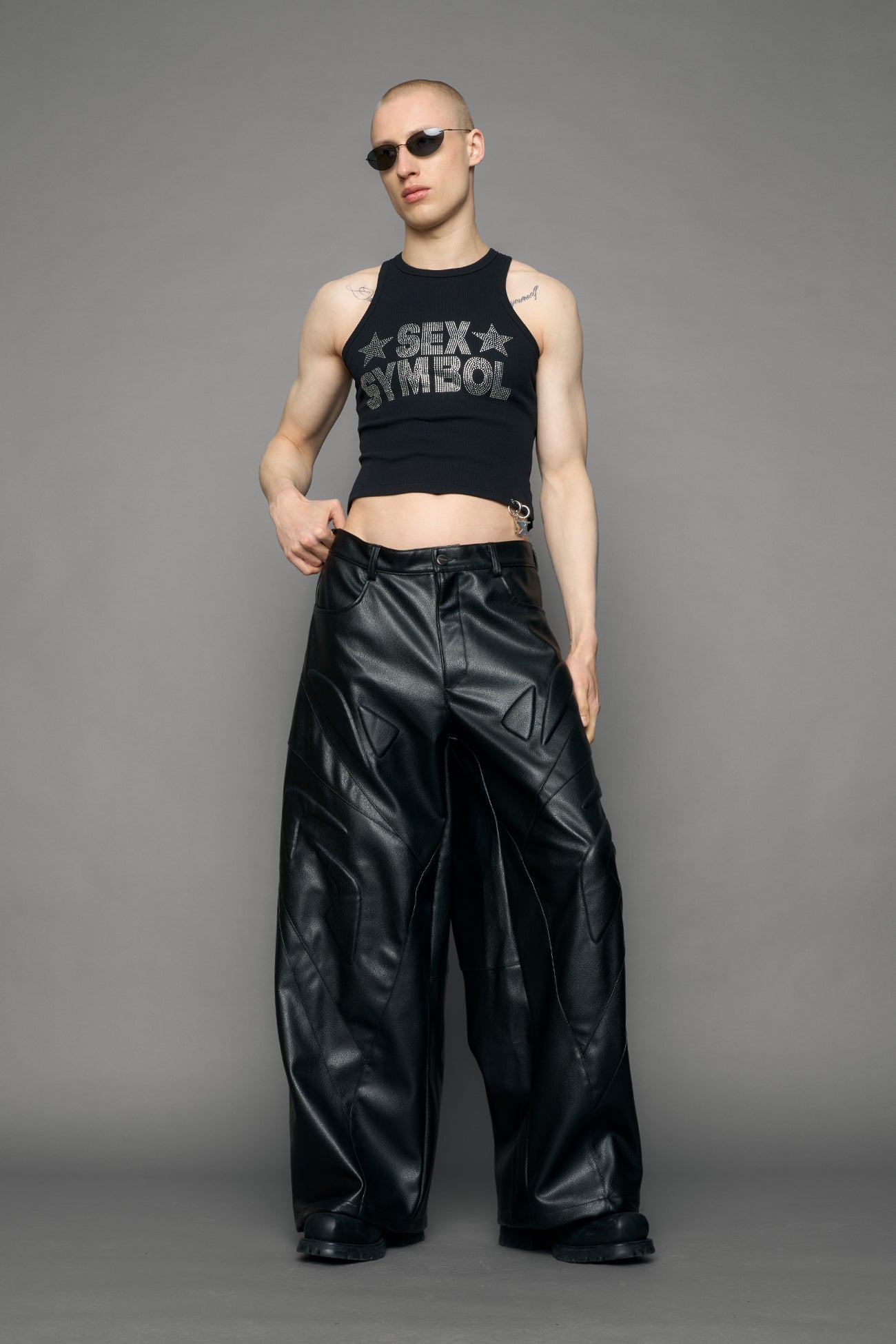 model wearing black oversize pu leather pants with moto style highlights