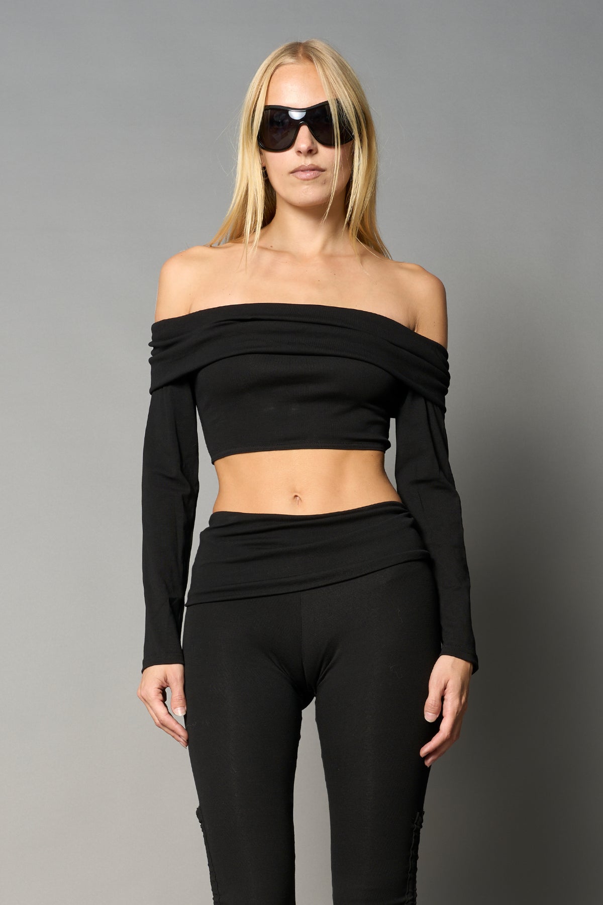 model wearing off shoulder top black with foldover detail and long sleeves