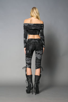 model wearing off shoulder top black print with foldover detail and long sleeves