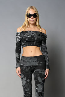 model wearing off shoulder top black print with foldover detail and long sleeves