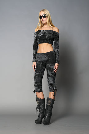 model wearing off shoulder top black print with foldover detail and long sleeves