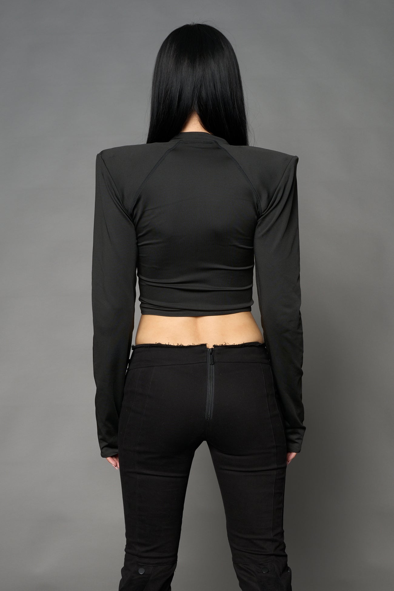 Namilia Pagoda Top in black with sharp padded shoulders and zip front