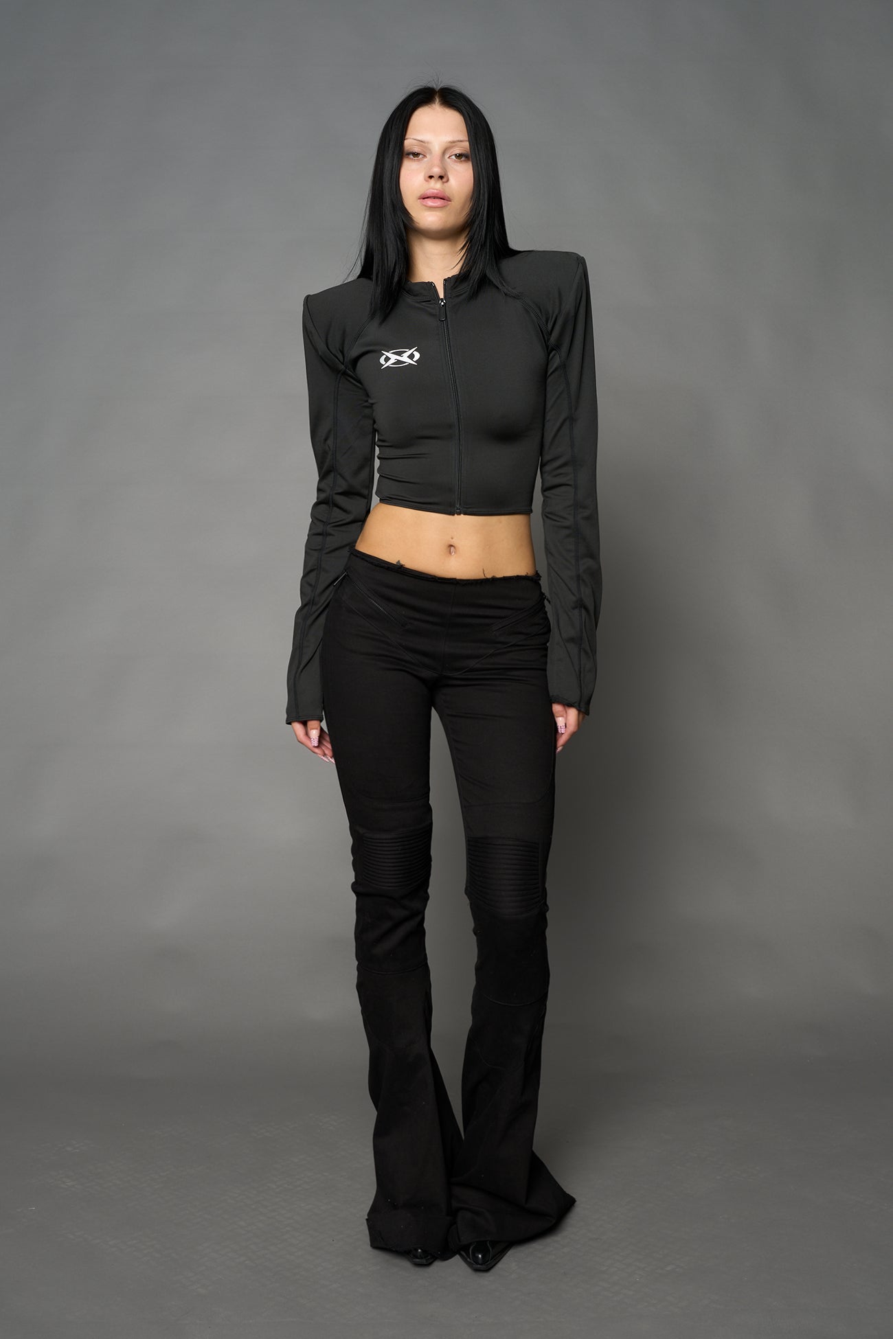 Namilia Pagoda Top in black with sharp padded shoulders and zip front