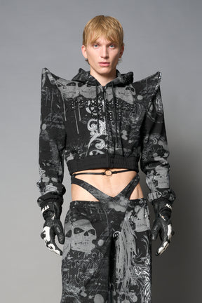 Model wearing a black print cropped hoodie with exaggerated spike shoulders, drawstring hood