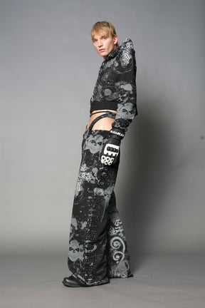 Model wearing a black print cropped hoodie with exaggerated spike shoulders, drawstring hood