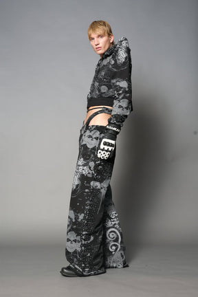 Model wearing a black print cropped hoodie with exaggerated spike shoulders, drawstring hood