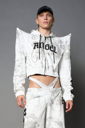 Model wearing a white print cropped hoodie with exaggerated spike shoulders, drawstring hood