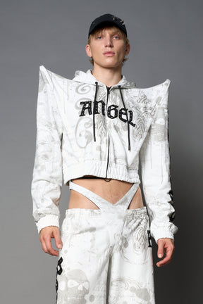 Model wearing a white print cropped hoodie with exaggerated spike shoulders, drawstring hood