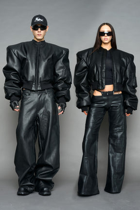 model wearing black vegan leather bomber jacket with large shoulders
