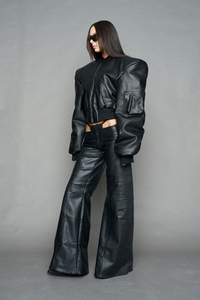 model wearing black vegan leather bomber jacket with large shoulders