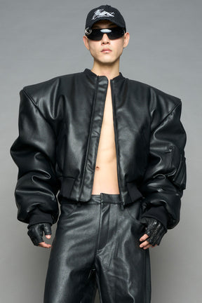 model wearing black vegan leather bomber jacket with large shoulders
