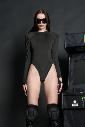 Model wears a long-sleeved black lycra stretch bodysuit with string back and detachable padded shoulders, contrast coverstitch , thumbhole gloves.