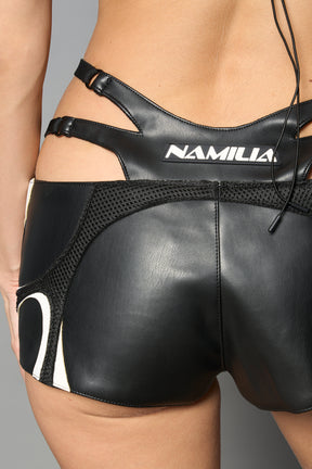white vegan leather sneaker-inspired hot pants with lace-up sides, cut-out hips, and front zip – edgy Y2K shorts for festival or streetwear looks.
