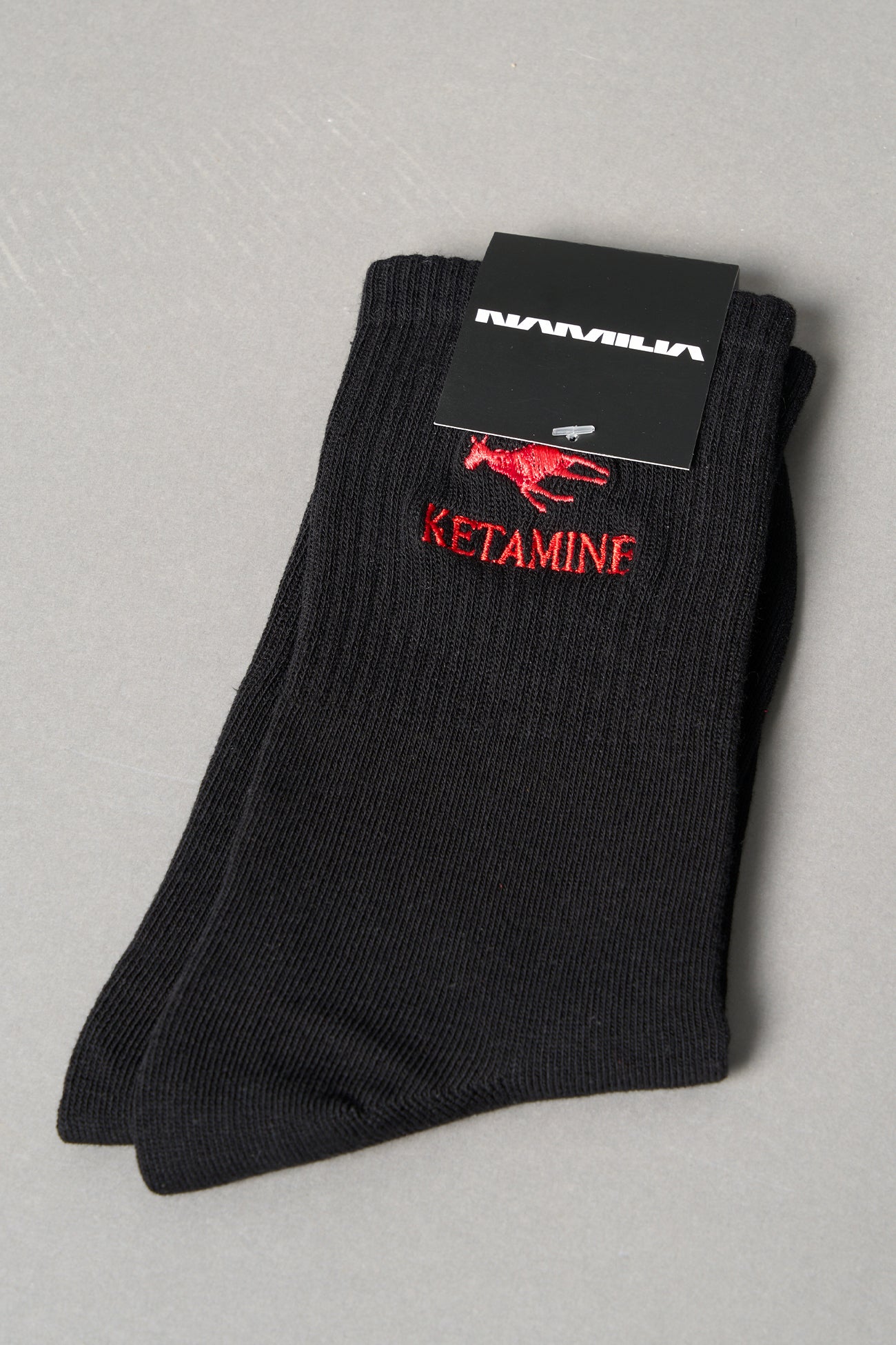 Black ribbed sport socks with red embroidered dragon and bold ‘KETAMINE’ slogan by Namilia, unisex mid-calf fit.