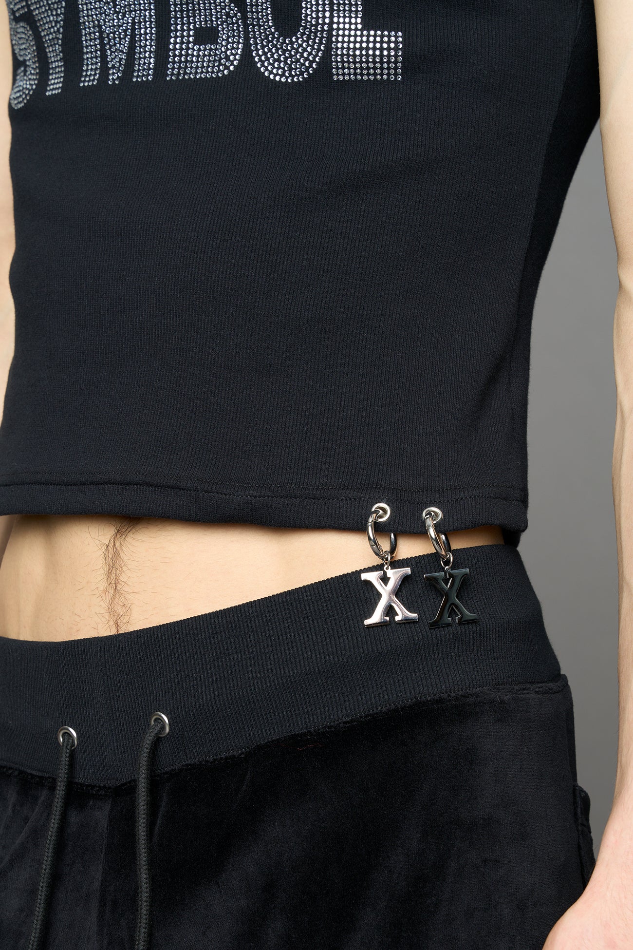 model wearing black x symbol crystal tank top in cotton rib