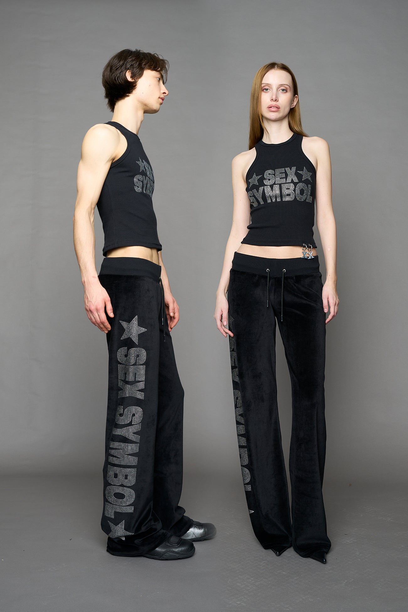 Black velour pants with NAMILIA x Symbol rhinestone detailing and a fitted straight-leg silhouette