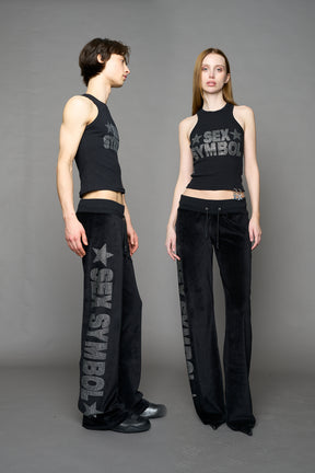 Black velour pants with NAMILIA x Symbol rhinestone detailing and a fitted straight-leg silhouette