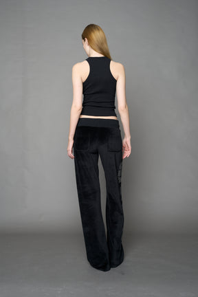 Black velour pants with NAMILIA x Symbol rhinestone detailing and a fitted straight-leg silhouette