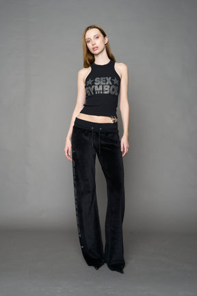 Black velour pants with NAMILIA x Symbol rhinestone detailing and a fitted straight-leg silhouette