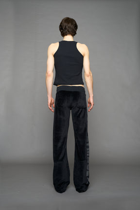 Black velour pants with NAMILIA x Symbol rhinestone detailing and a fitted straight-leg silhouette
