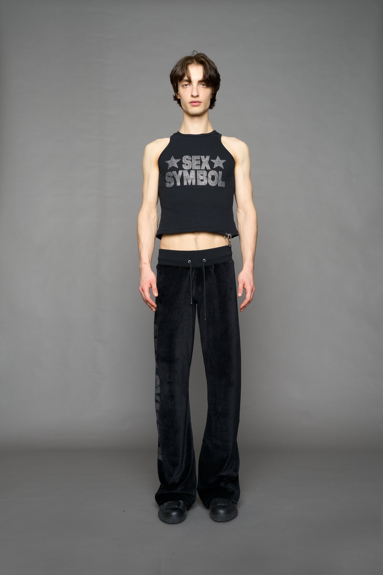 Black velour pants with NAMILIA x Symbol rhinestone detailing and a fitted straight-leg silhouette
