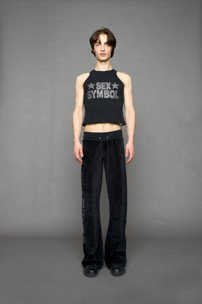 Black velour pants with NAMILIA x Symbol rhinestone detailing and a fitted straight-leg silhouette