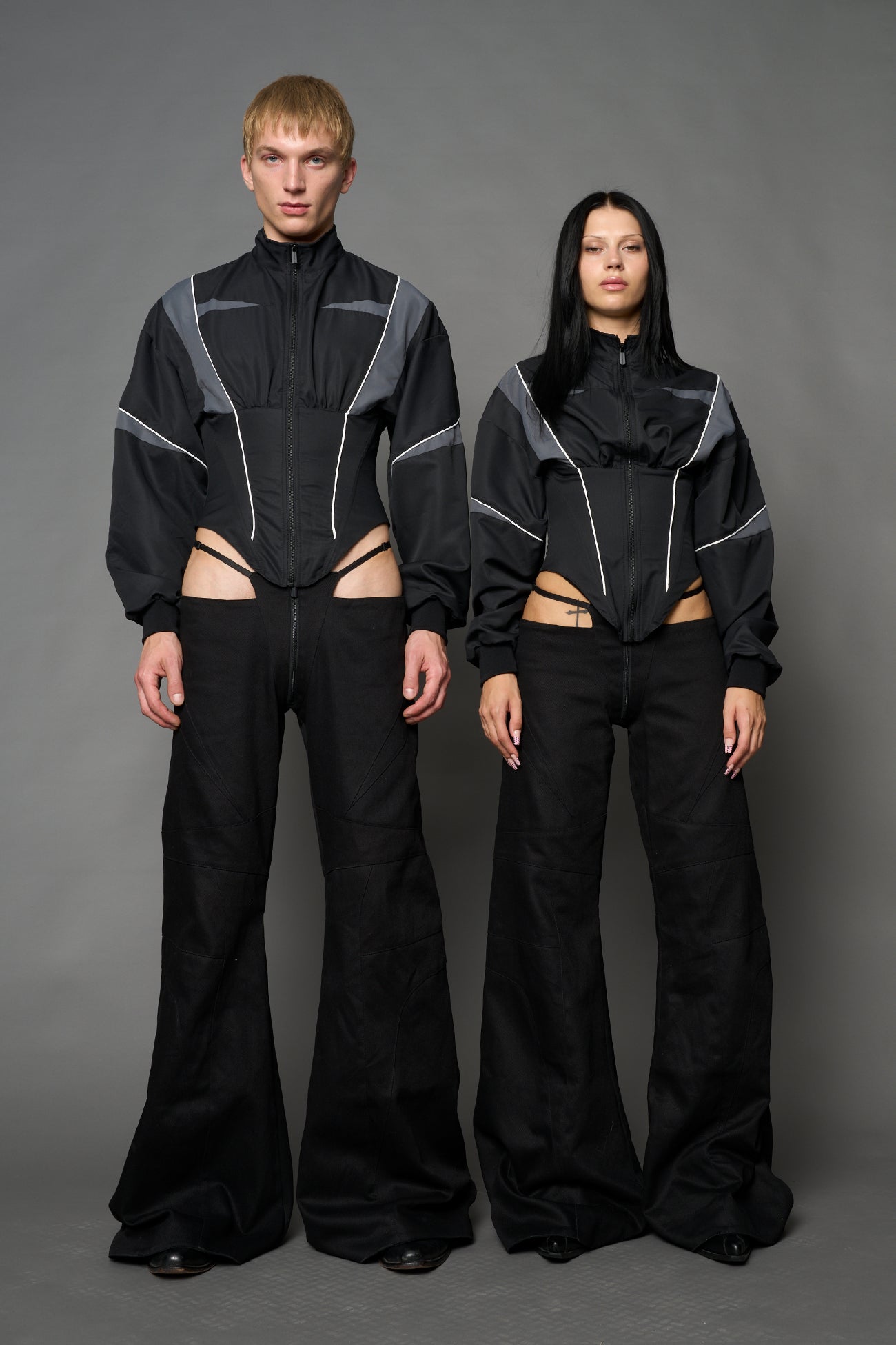 Black Namilia tracksuit jacket with grey sleeve stripes and lace-up corset back