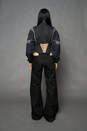 Black Namilia tracksuit jacket with grey sleeve stripes and lace-up corset back