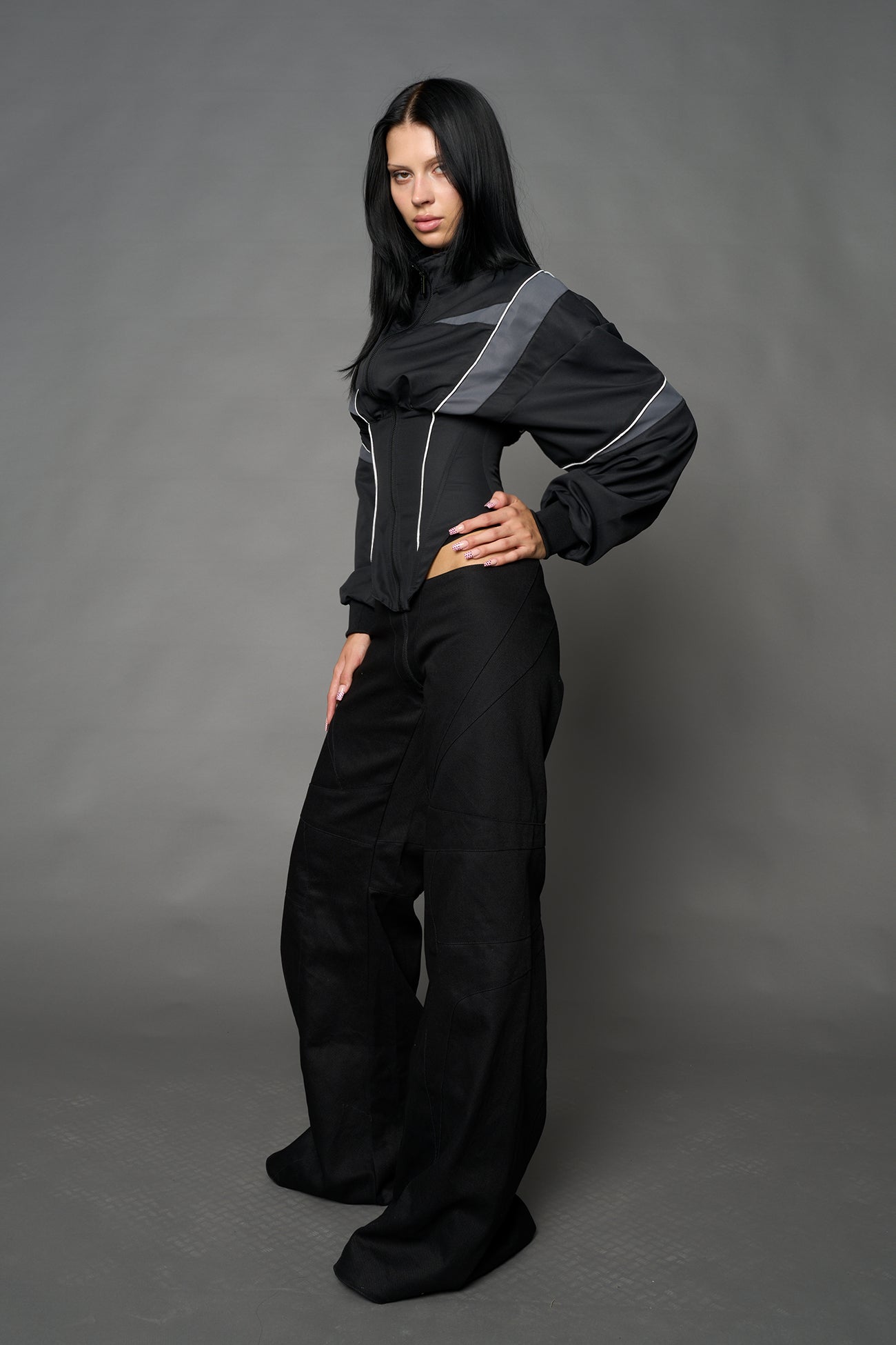 Black Namilia tracksuit jacket with grey sleeve stripes and lace-up corset back