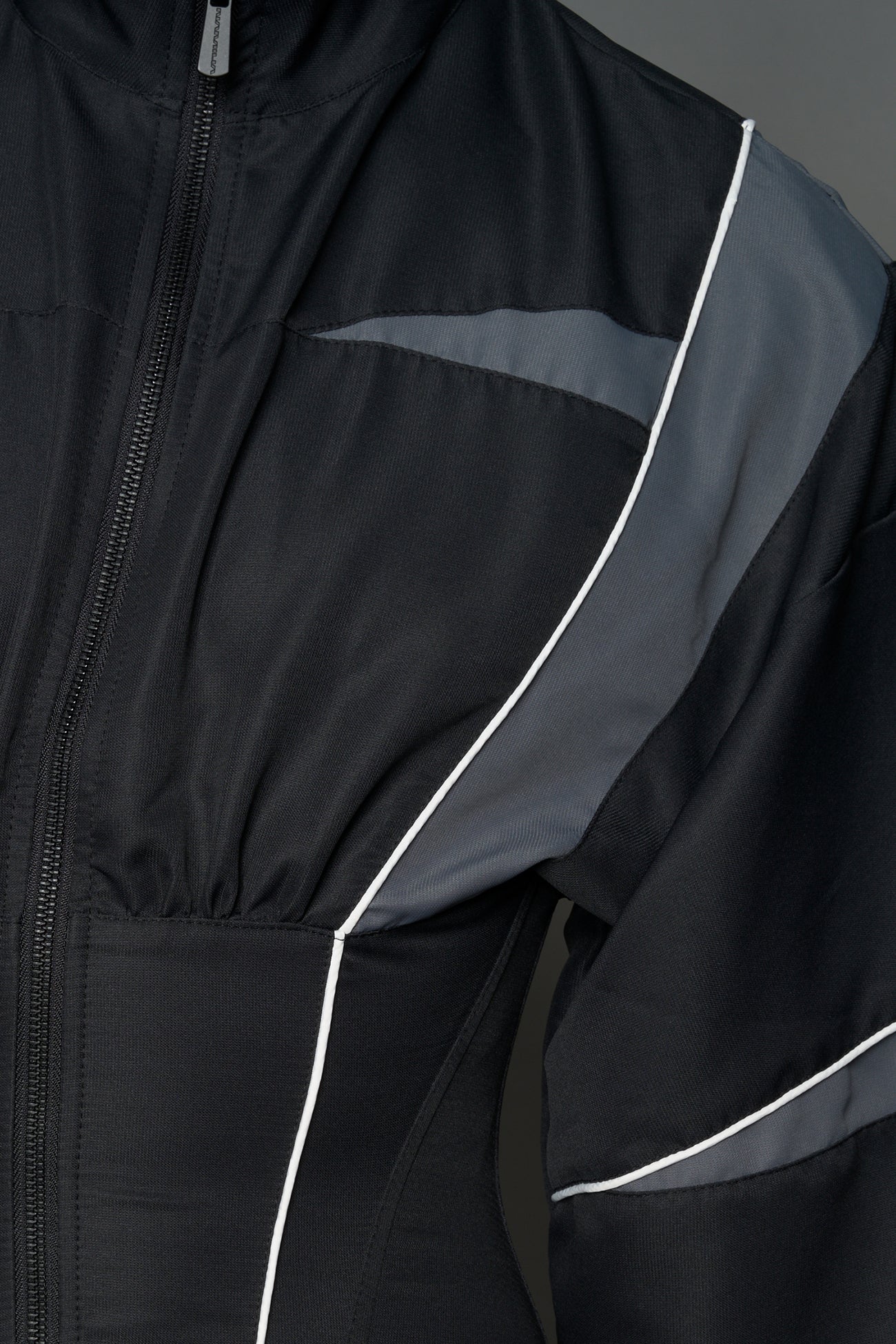 Black Namilia tracksuit jacket with grey sleeve stripes and lace-up corset back