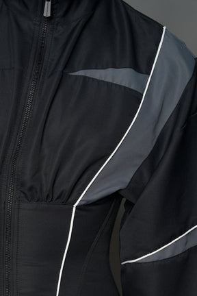 Black Namilia tracksuit jacket with grey sleeve stripes and lace-up corset back