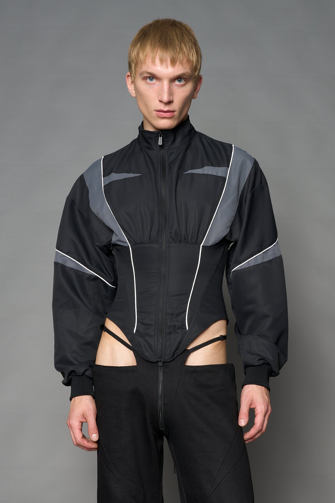 Black Namilia tracksuit jacket with grey sleeve stripes and lace-up corset back