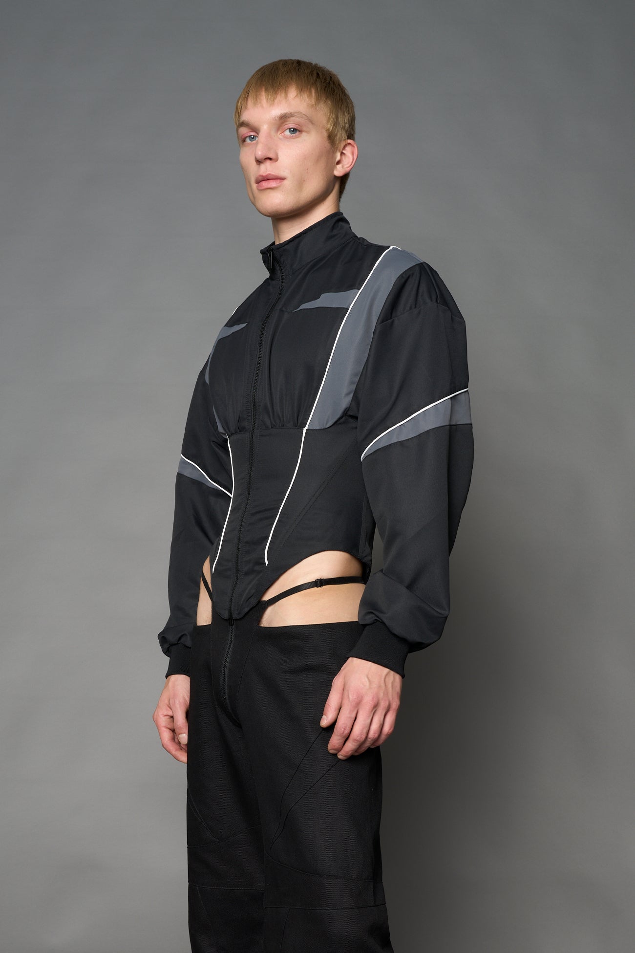 Black Namilia tracksuit jacket with grey sleeve stripes and lace-up corset back