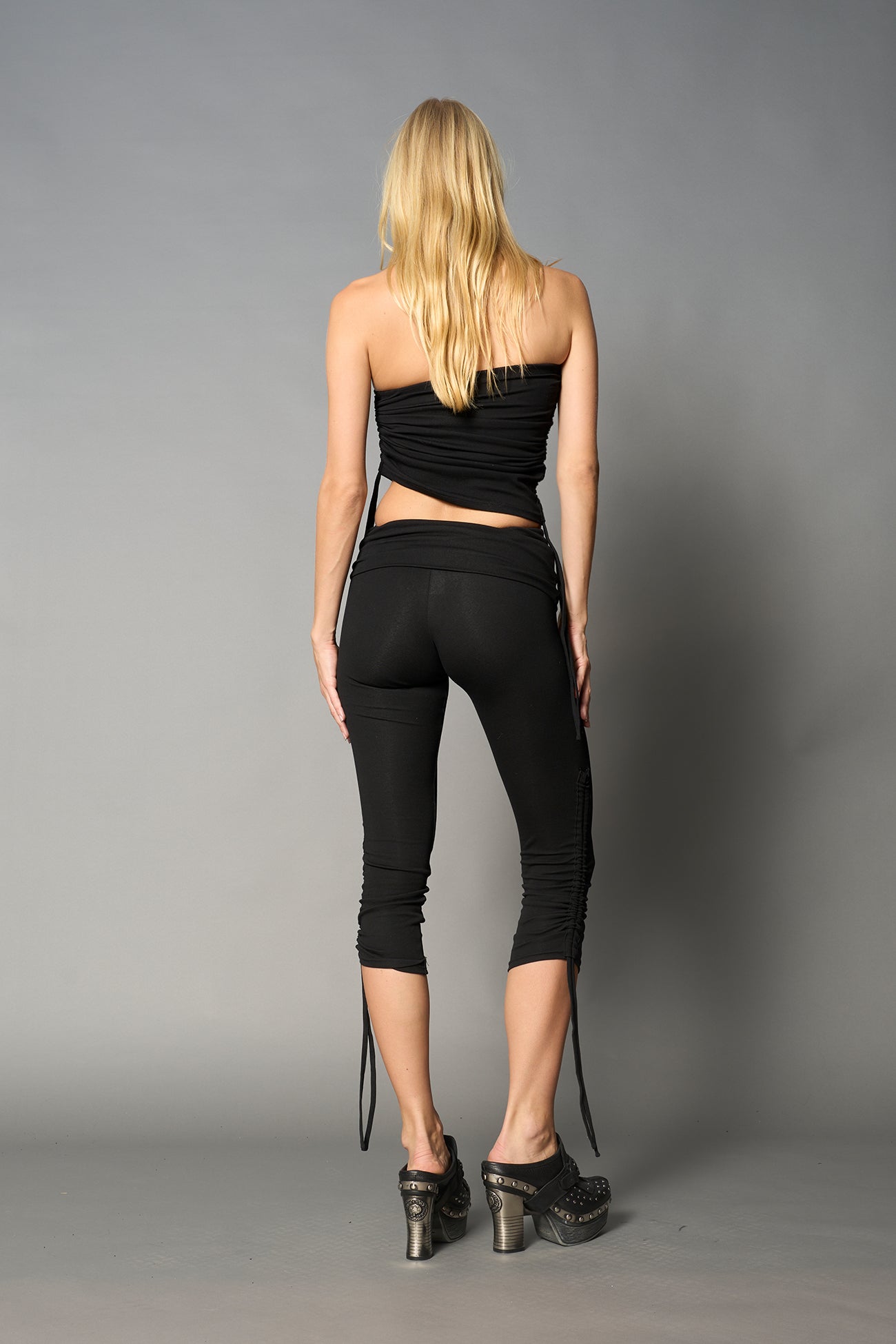 model wearing black soft jersey tbe top with ruching detail on the sides