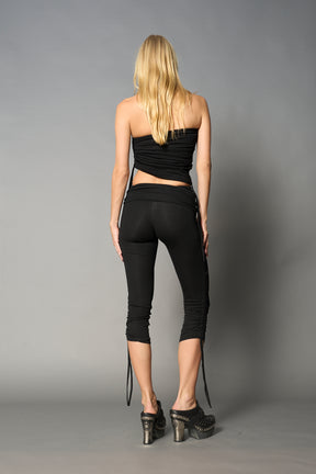 model wearing black soft jersey tbe top with ruching detail on the sides