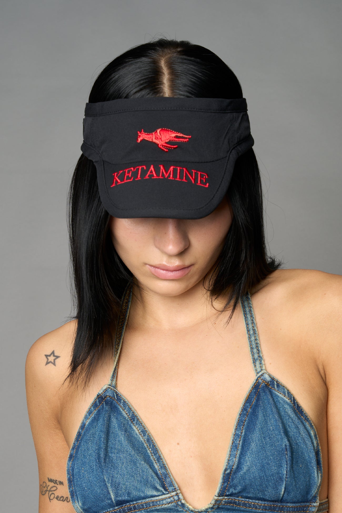 Black Namilia visor hat with embroidered horse and bold lettering on brim, unisex streetwear accessory