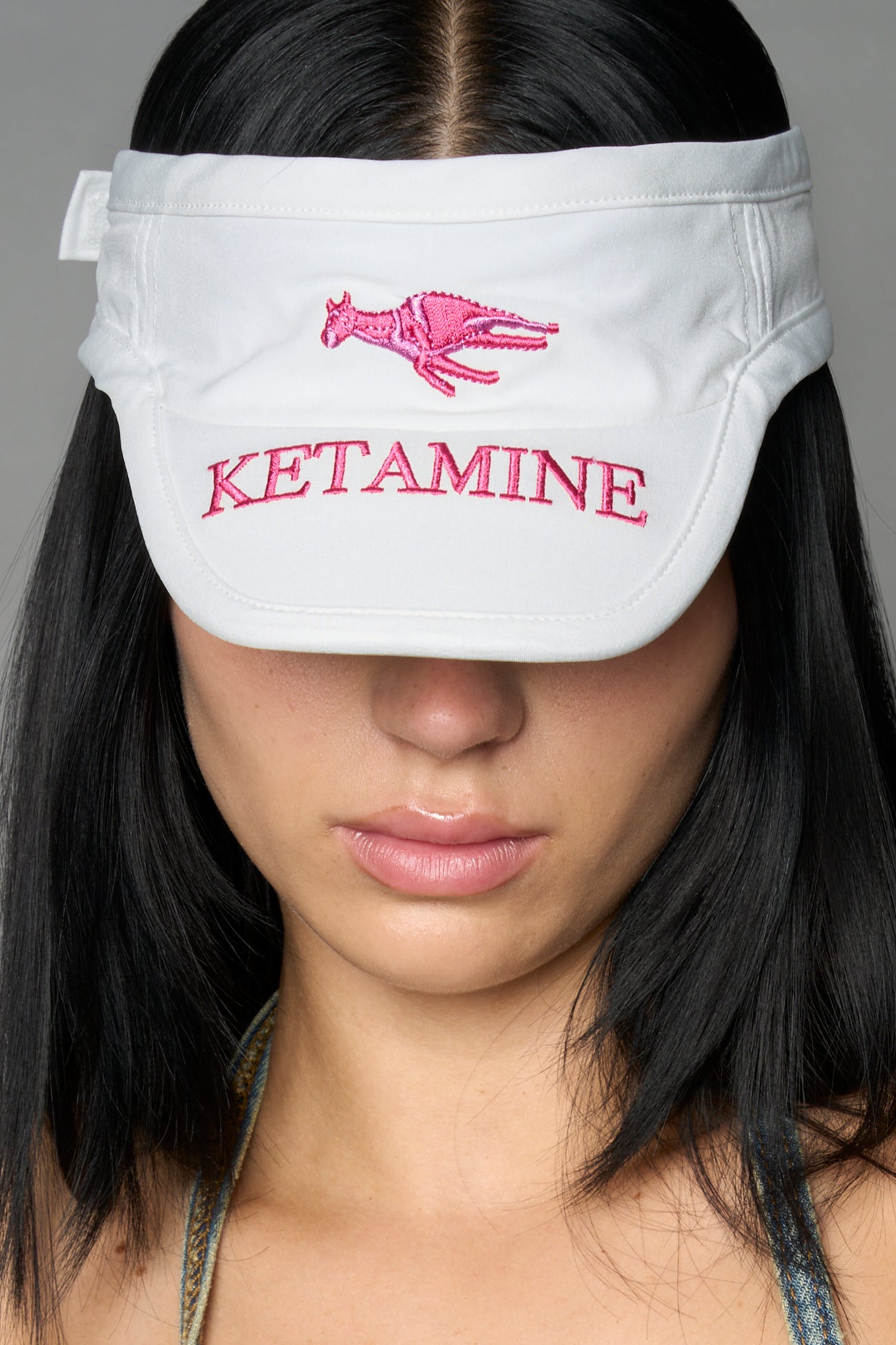 White Namilia visor hat with embroidered horse and bold lettering on brim, unisex streetwear accessory