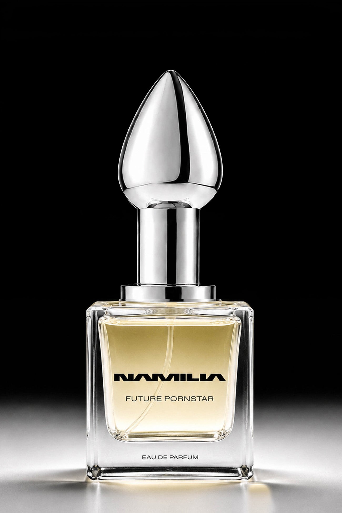 Namila perfume bottles with metallic silver shaped caps and clear glass bases, filled with pale yellow liquid