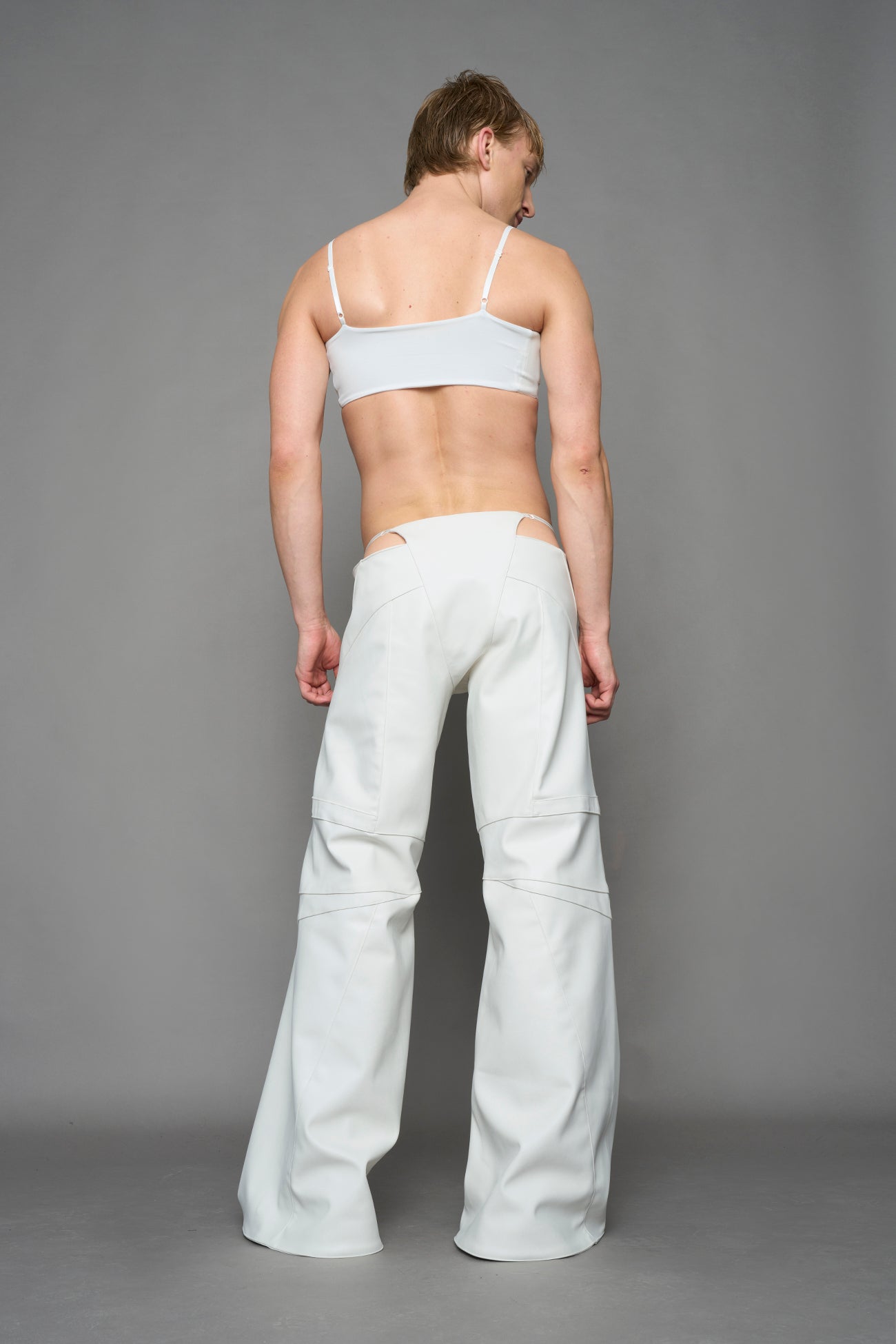 two models wearing white vegan leather pants with thong detail