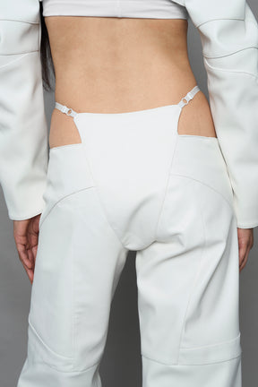 two models wearing white vegan leather pants with thong detail