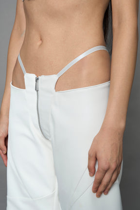 two models wearing white vegan leather pants with thong detail