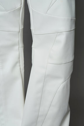 two models wearing white vegan leather pants with thong detail