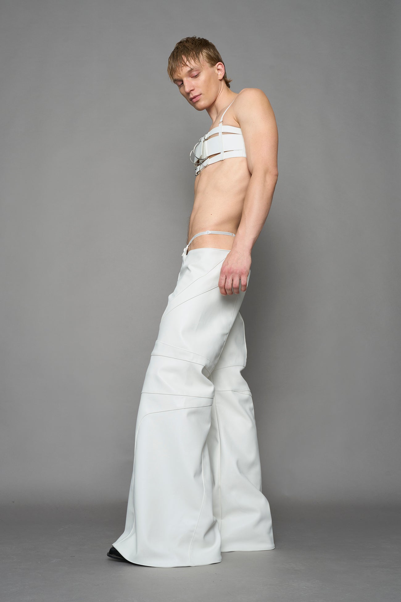 two models wearing white vegan leather pants with thong detail