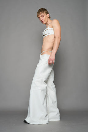 two models wearing white vegan leather pants with thong detail