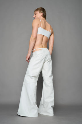 two models wearing white vegan leather pants with thong detail